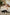 Couple lying on bedlore mattress topper with a dog in a home setting