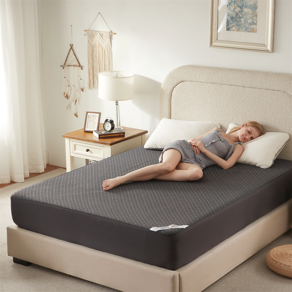 a woman lying down on the soft prismatic print mattress protector, gray