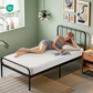a woman is lying on the waterproof prismatic print noiseless mattress protector, white