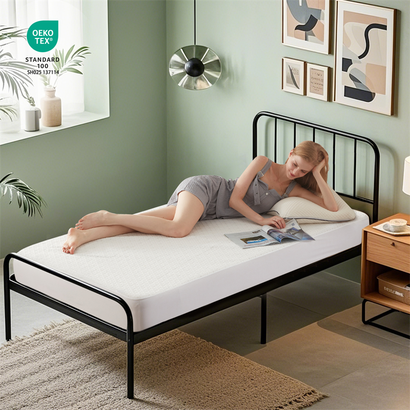 a woman is lying on the waterproof prismatic print noiseless mattress protector, white