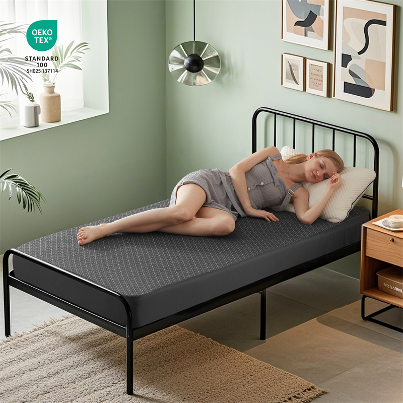 a woman is lying on the waterproof prismatic print noiseless mattress protector, gray