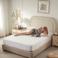 a woman lying down on Bedlore soft prismatic print mattress protector